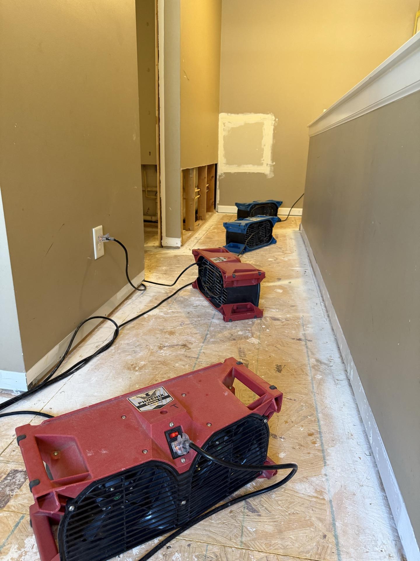 Air movers running in a Memphis hallway during emergency water mitigation