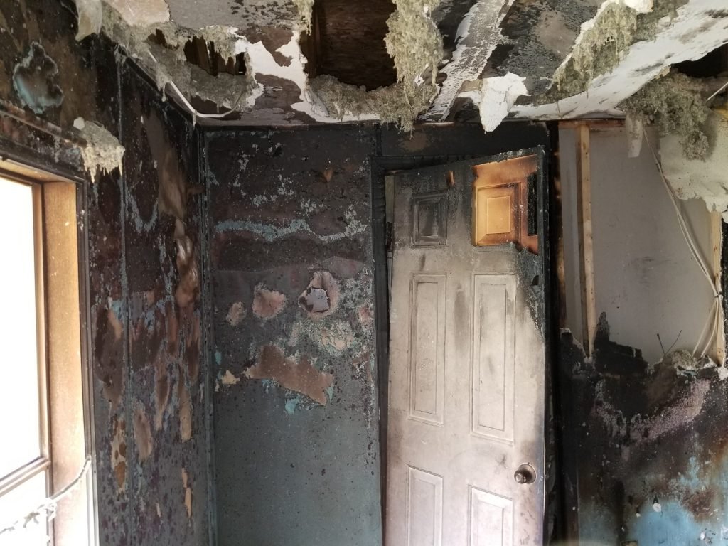 The walls, doors, and ceiling are badly burned from a house fire - Independent Restoration Services - West Tennessee and North Mississippi.